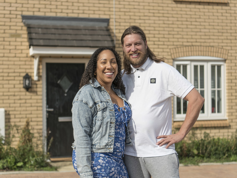 Young Couple Smiling Outside Home Homeowners