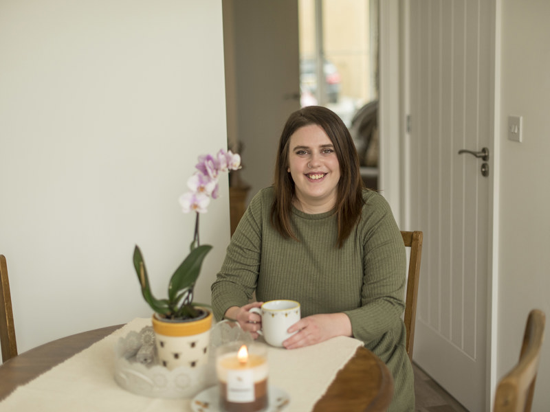 Customer In Living Room With Mug