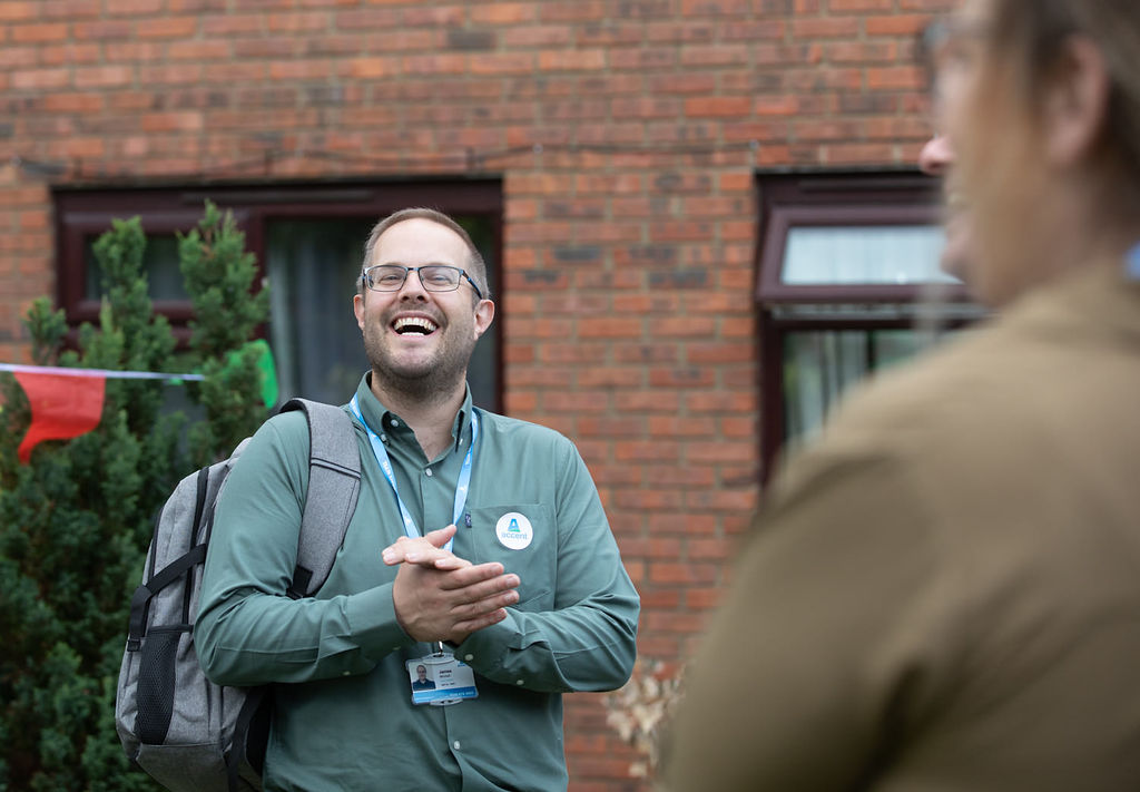 Laughing Colleague At A Scheme With Customer