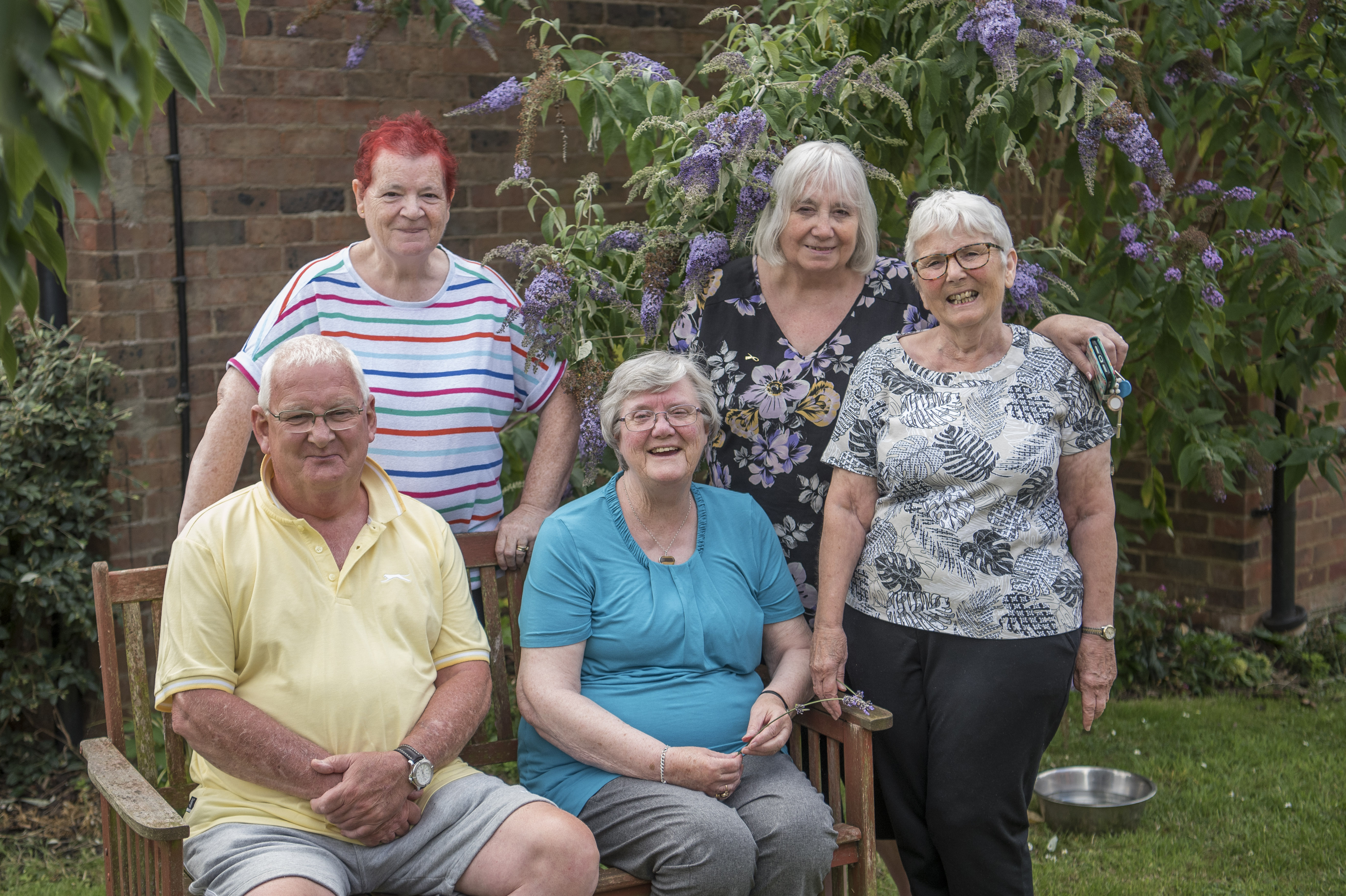 Group Of Older Adults In Garden Smiling