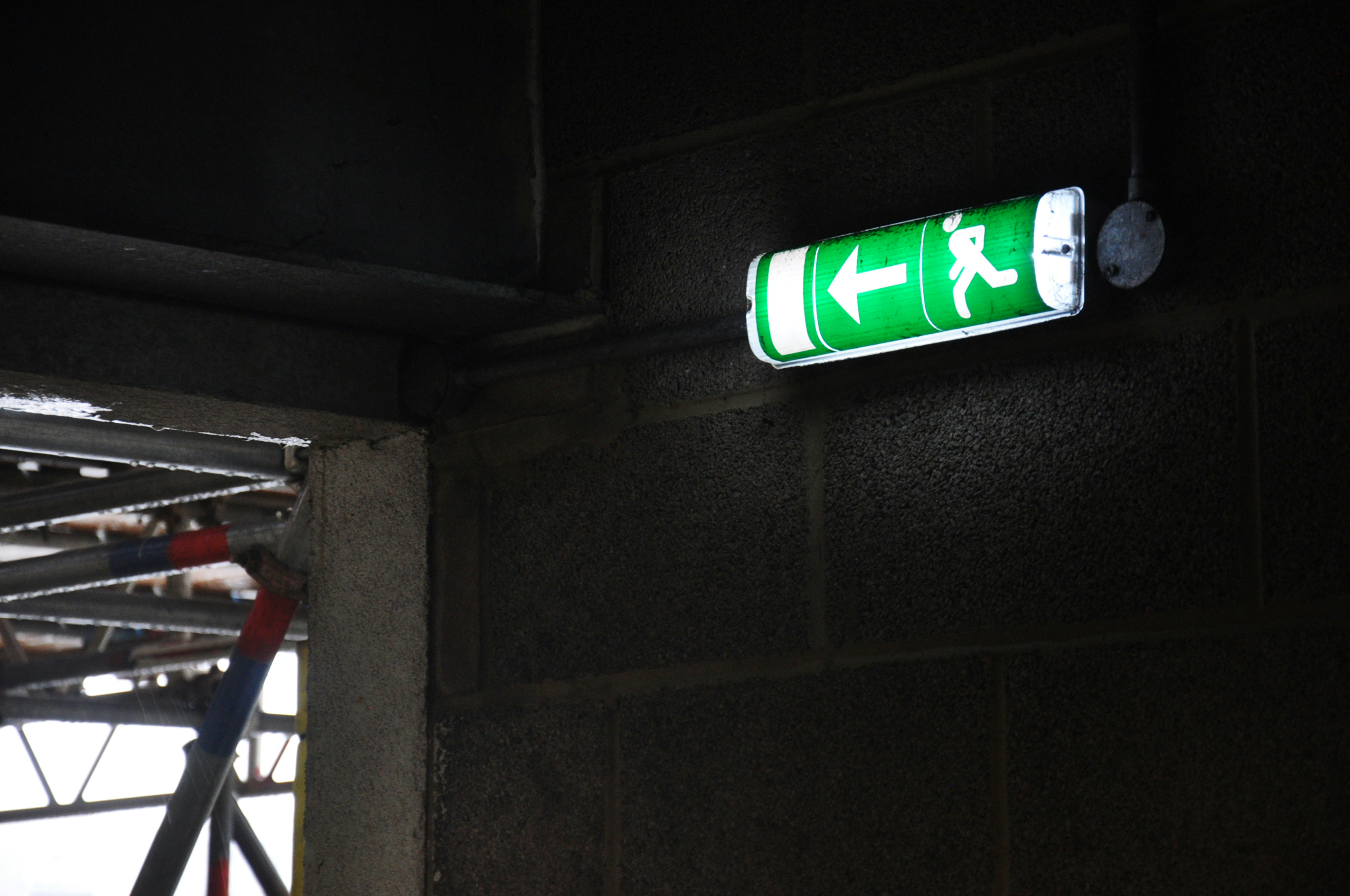 A bright green fire escape sign